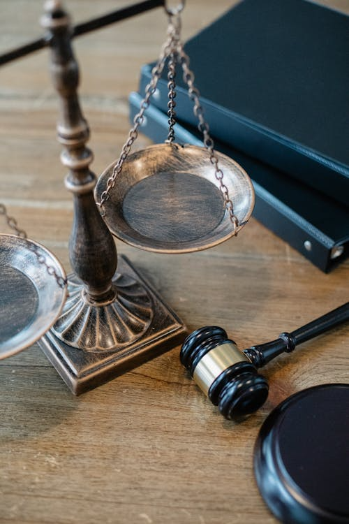 justice scale and gavel on a wooden surface