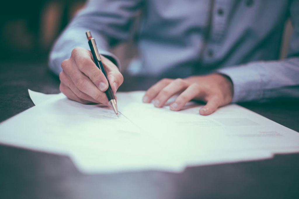 A person signing papers