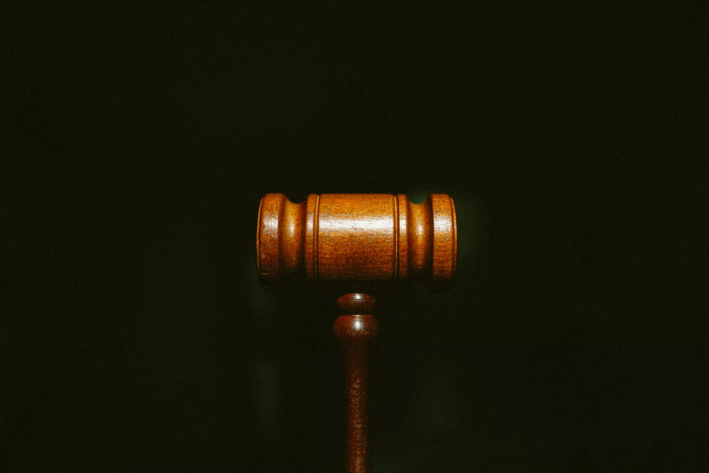An image of a brown hammer on a black background