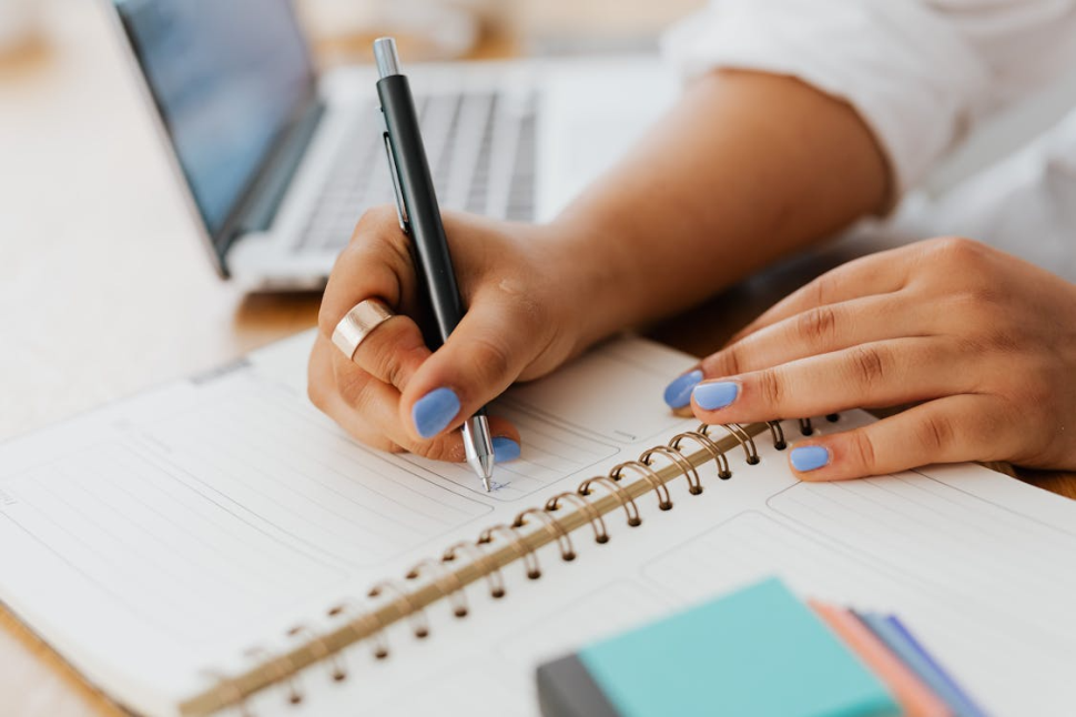An image of a person writing in a notebook