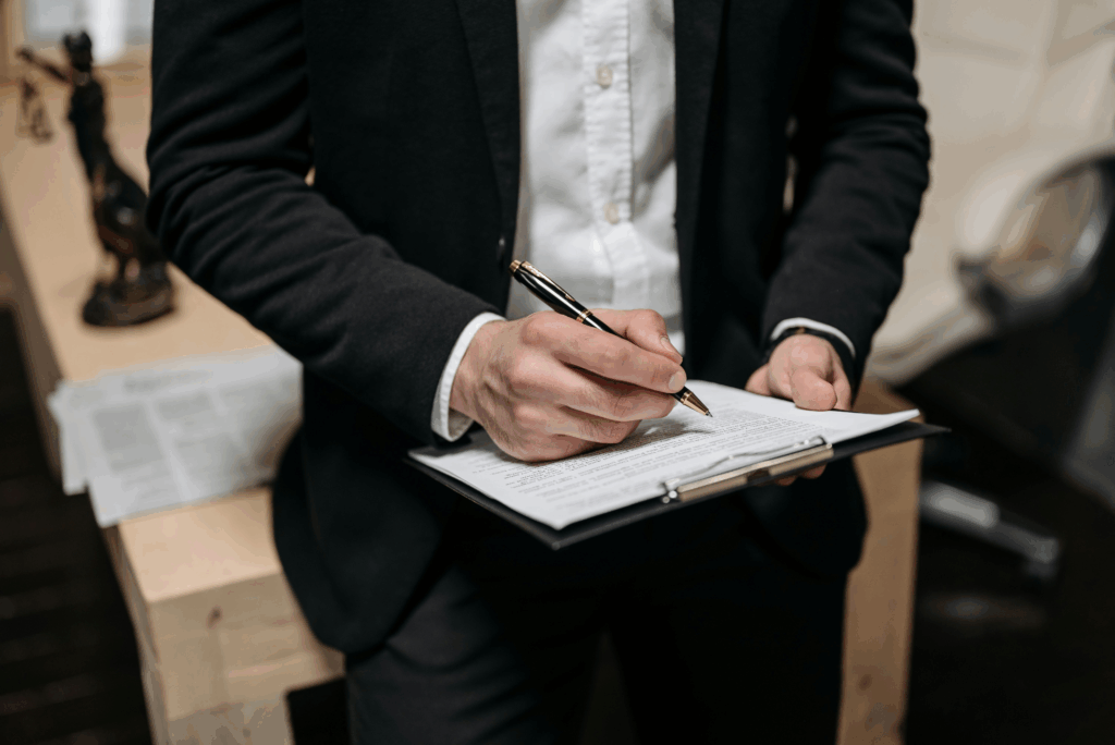 Close-up of a person holding a clipboard, reviewing legal case details