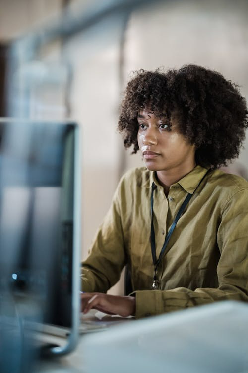 HR professional conducting an employee background check on a computer screen in a corporate office setting
