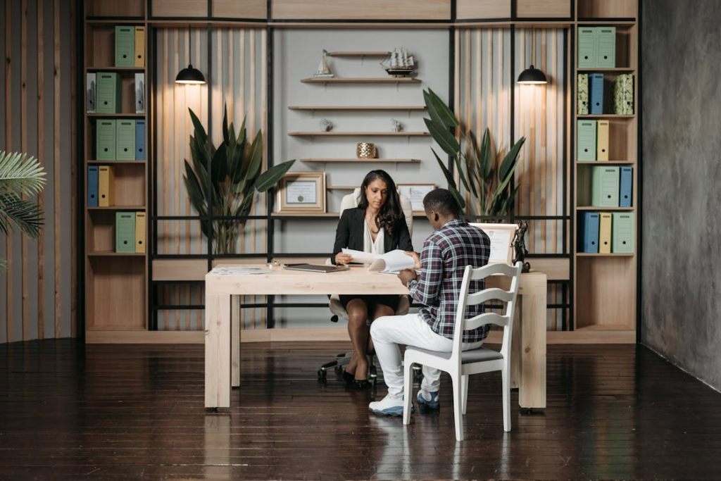 Lawyer in a professional office providing advice to a client seated across the desk