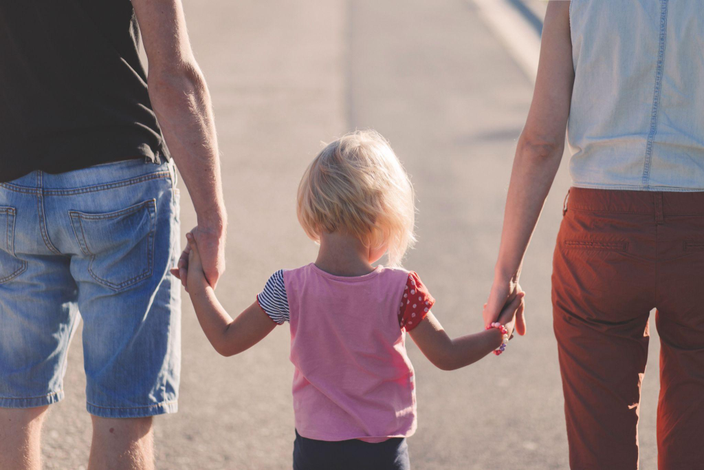 a child standing with their parents