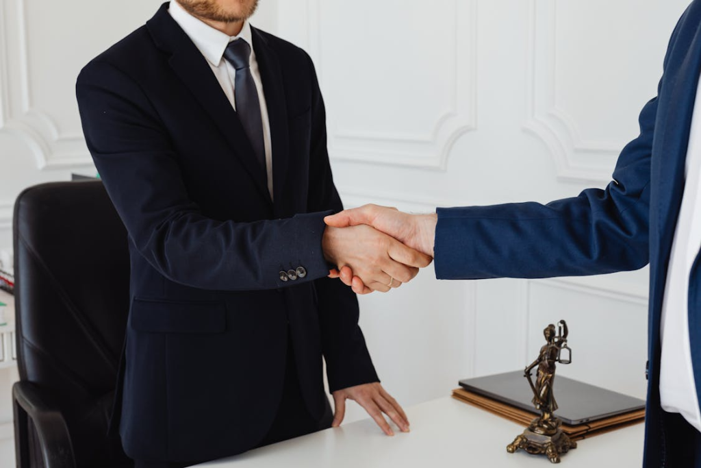 a client and a lawyer shaking hands
