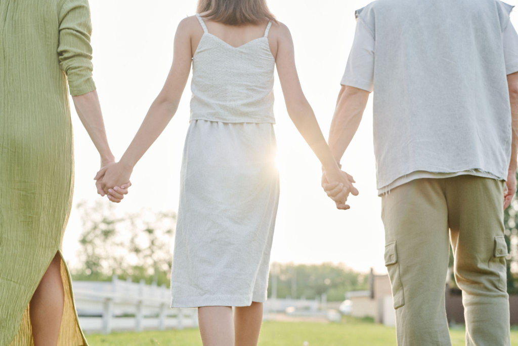 a family of three standing together