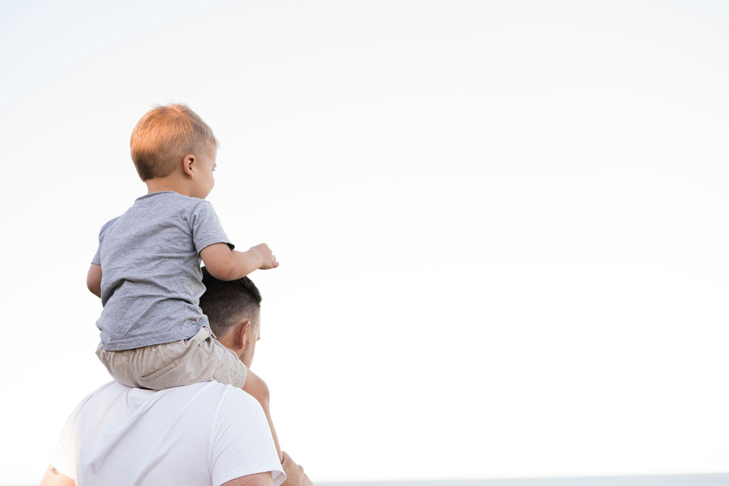 a father carrying his son on his shoulders