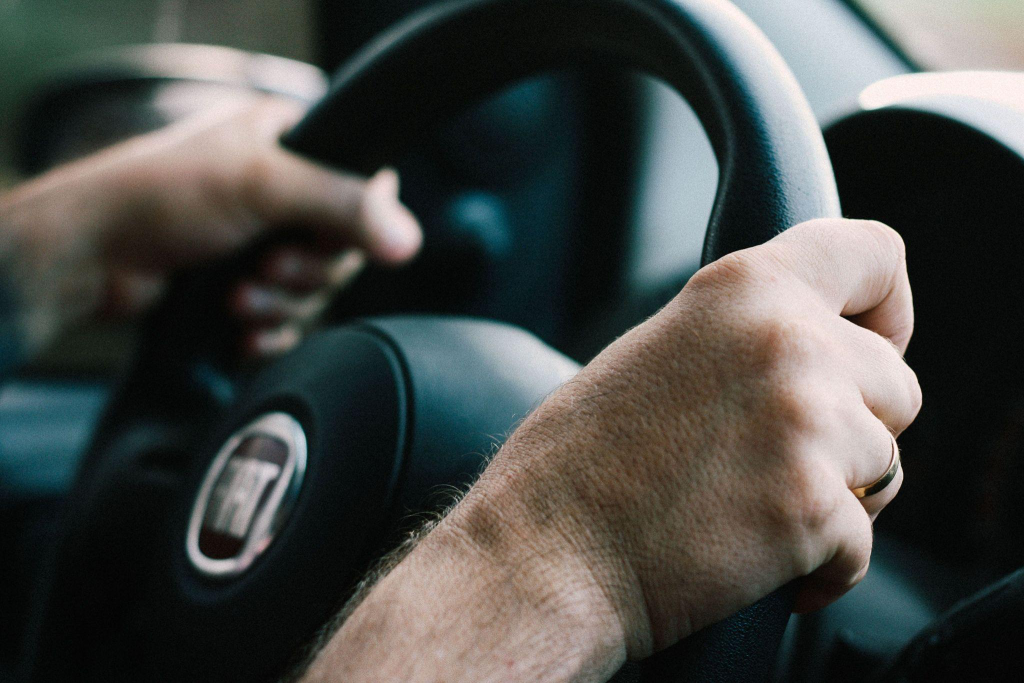 a person behind the wheel in a car