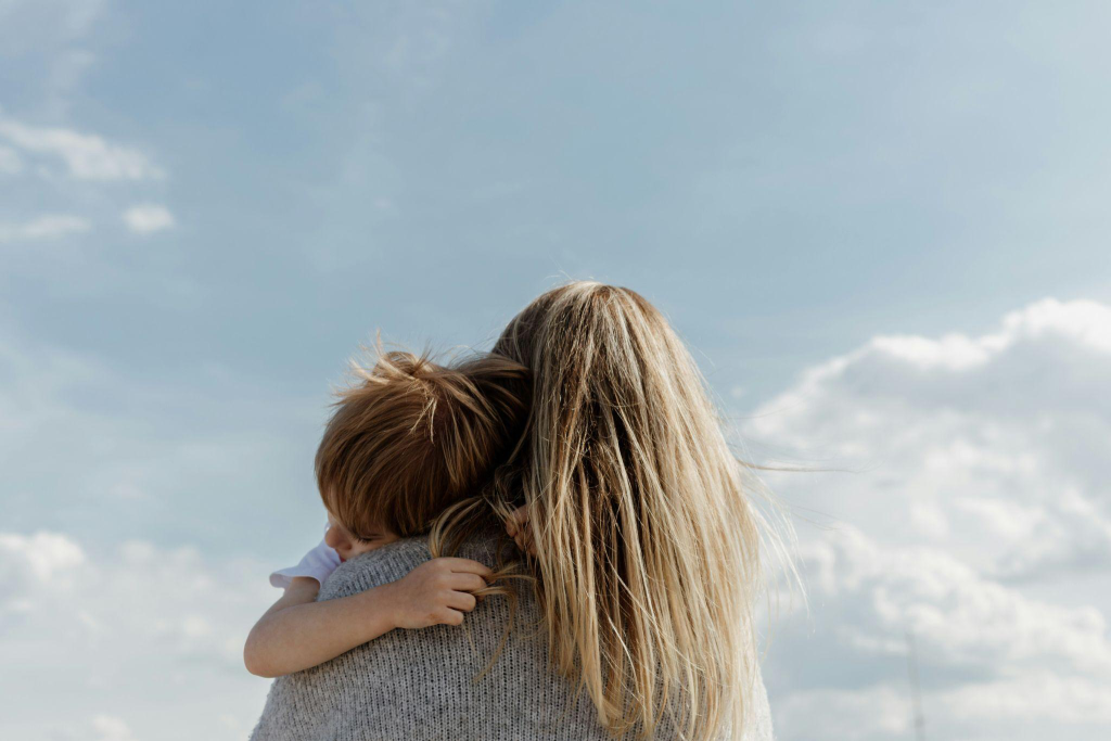 a woman holding a kid in her arms