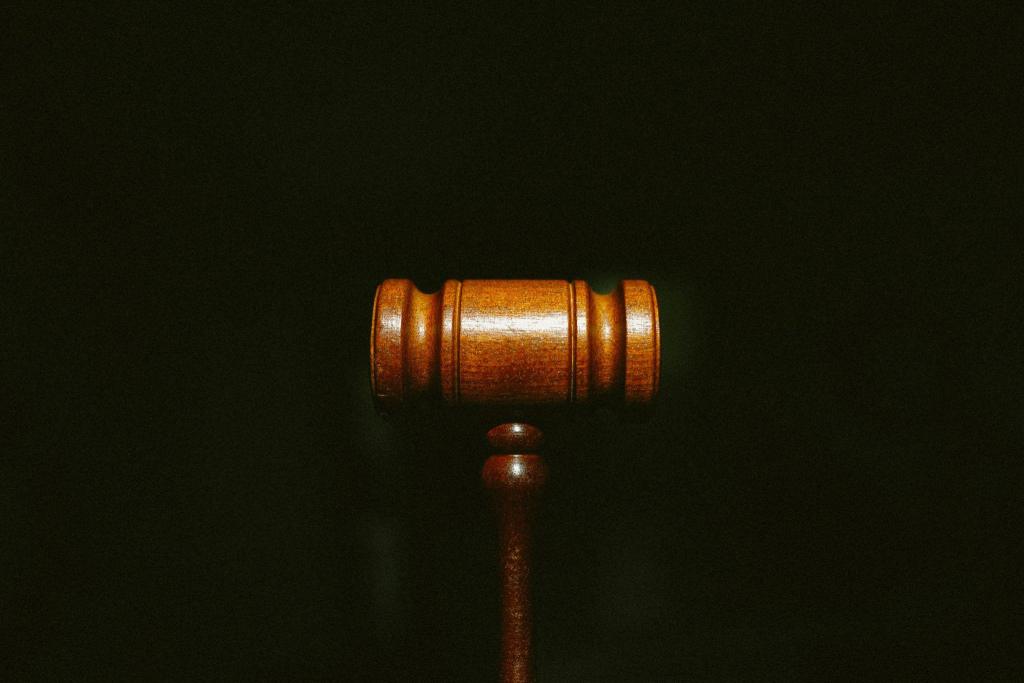 a wooden gavel against a black background