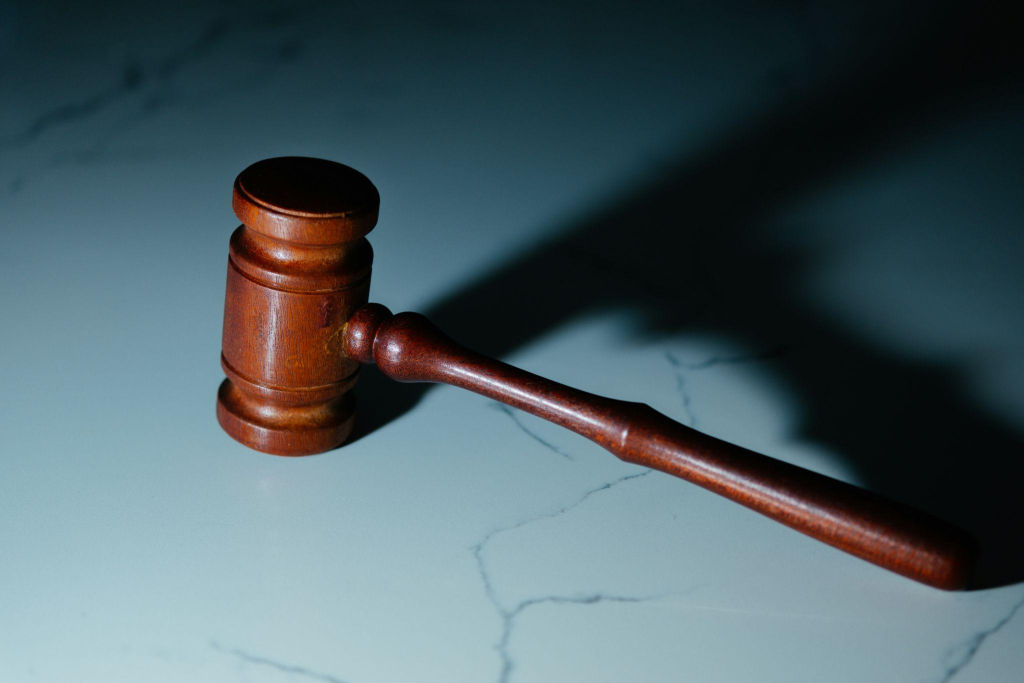 a wooden gavel on a marble surface