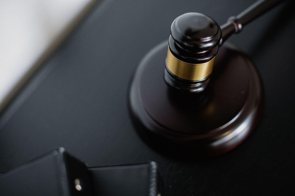 a wooden gavel placed on a black surface
