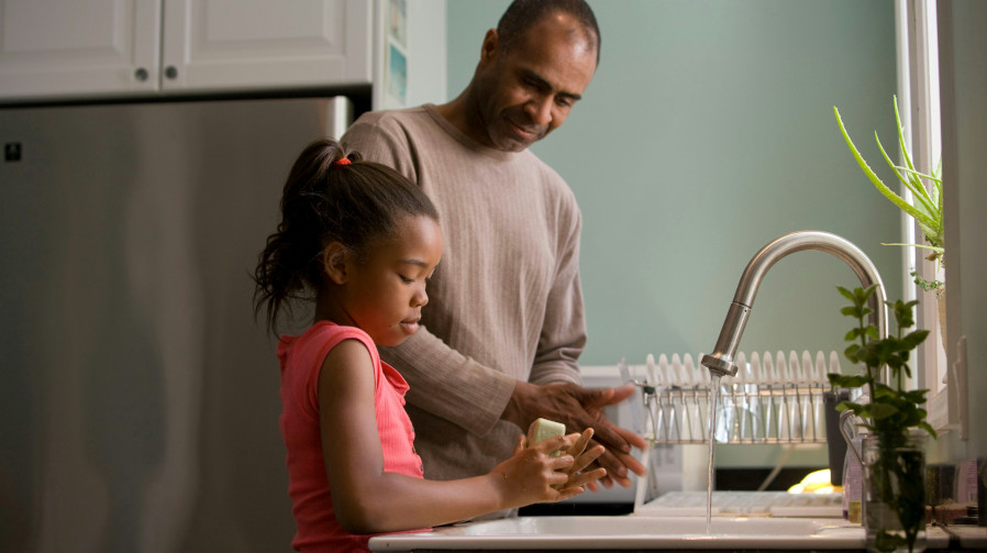 child doing chores with the father