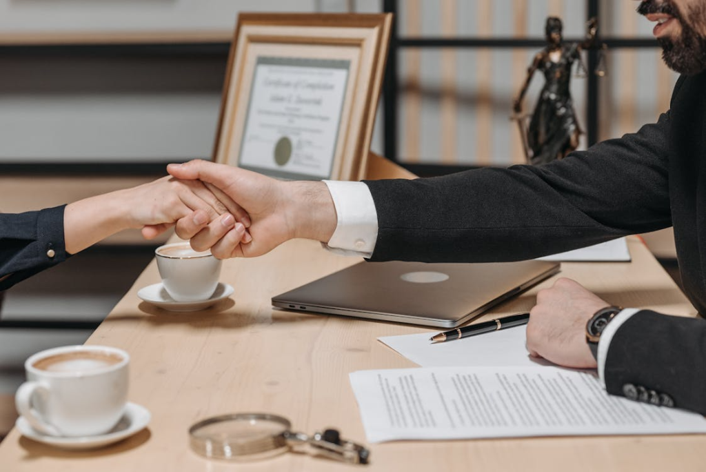 close-up of a lawyer and client shaking hands